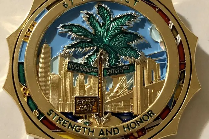 The NYPD confirmed that this coin, which depicts a palm tree in front of the city skyline and uses precinct nickname “Fort Jah,” was sold at the 67th Precinct in East Flatbush as part of a 2017 fundraiser.